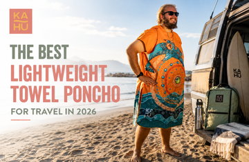 Lightweight microfiber towel poncho packed in its pouch next to a carry-on bag
