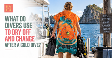 Diver drying off under a hooded Max towel poncho on a boat deck